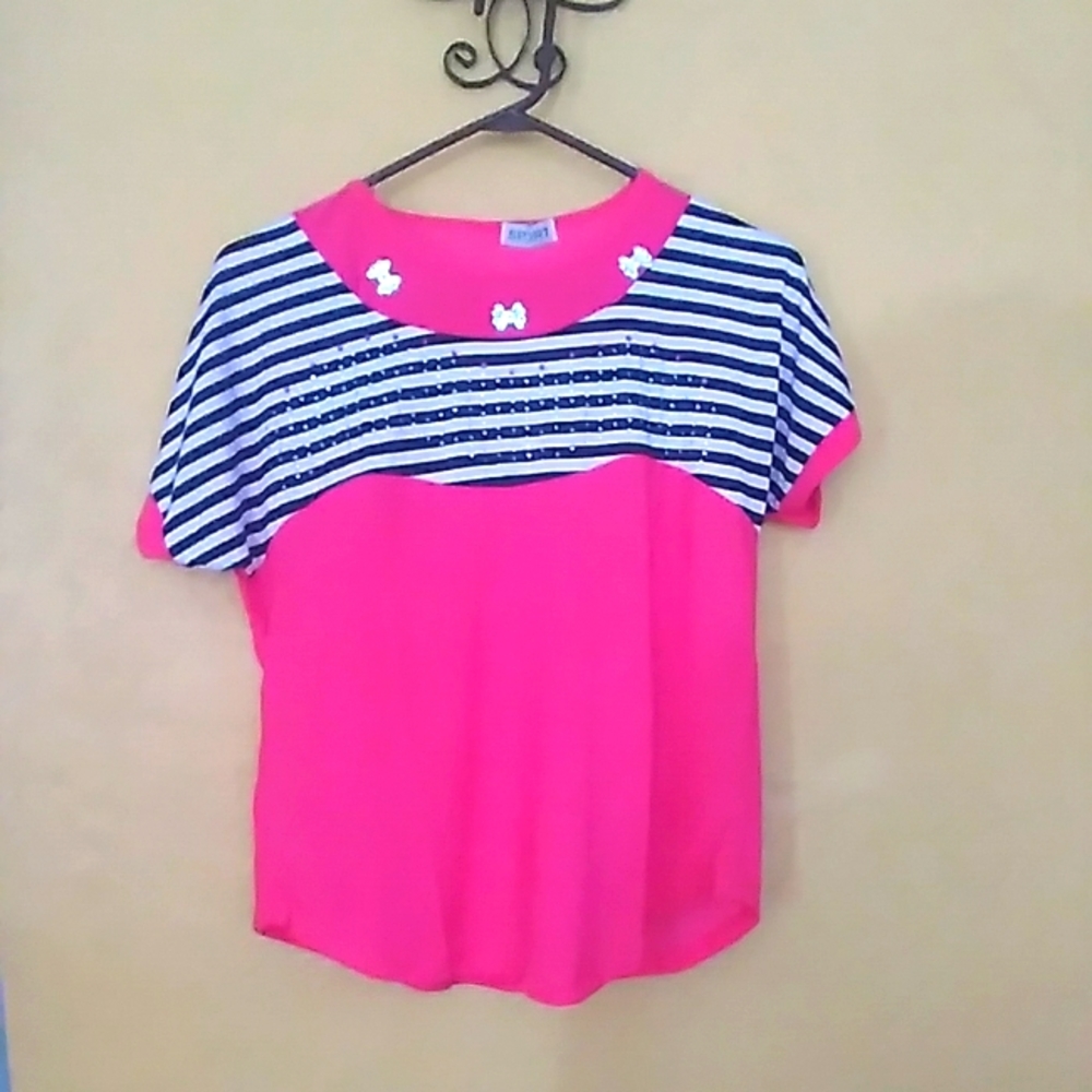 Pink blouse with top details.